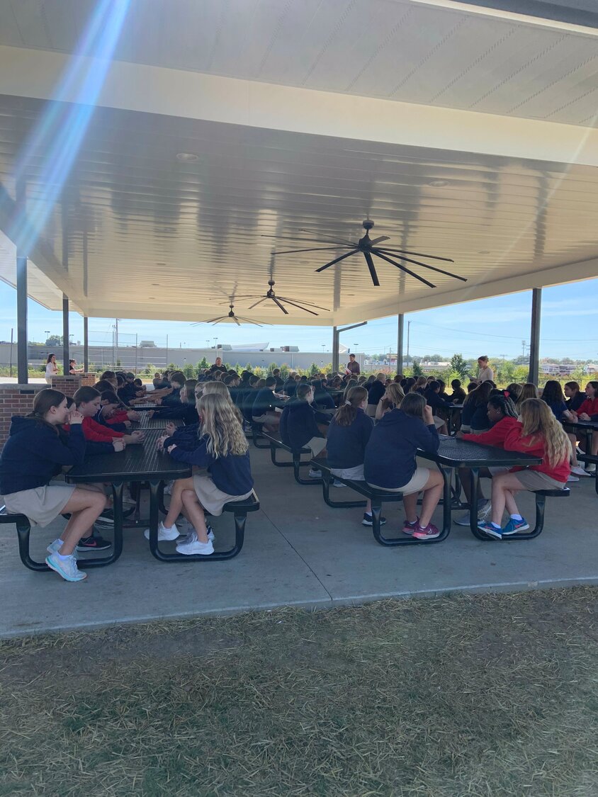 Students at Our Lady of Lourdes Interparish School in Columbia pray the Rosary for peace in the Holy Land, in the school’s new outdoor classroom on Oct. 17.